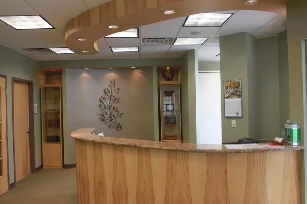 The curved wooden reception desk at Twin Hickory Dental.