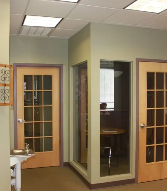 The hallway, with a glass-walled consultation room.